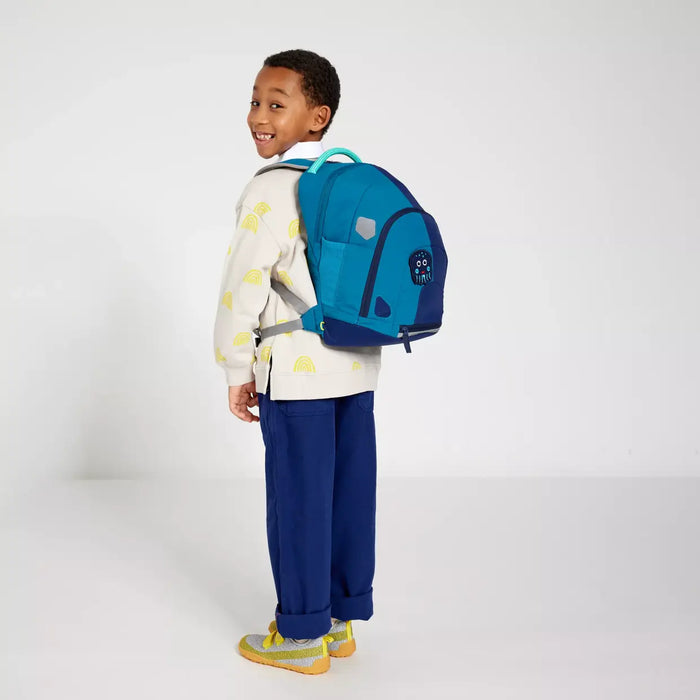 Boy wearing the Affenzahn Daydreamer Octopus Backpack in blue colors, showing ergonomic straps and spacious design for school or travel.