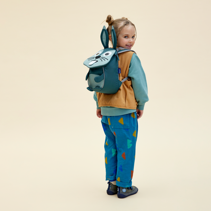 Affenzahn Small Friend Rabbit backpack worn by a toddler, illustrating its size and fit.