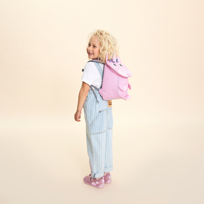Affenzahn Small Friend Unicorn backpack worn by a toddler, illustrating its size and fit.