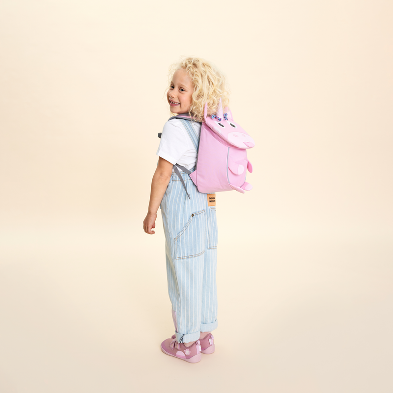 Affenzahn Small Friend Unicorn backpack worn by a toddler, illustrating its size and fit.