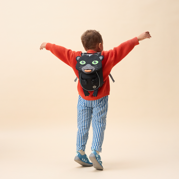 Affenzahn Small Friend Panther backpack worn by a toddler, illustrating its size and fit.