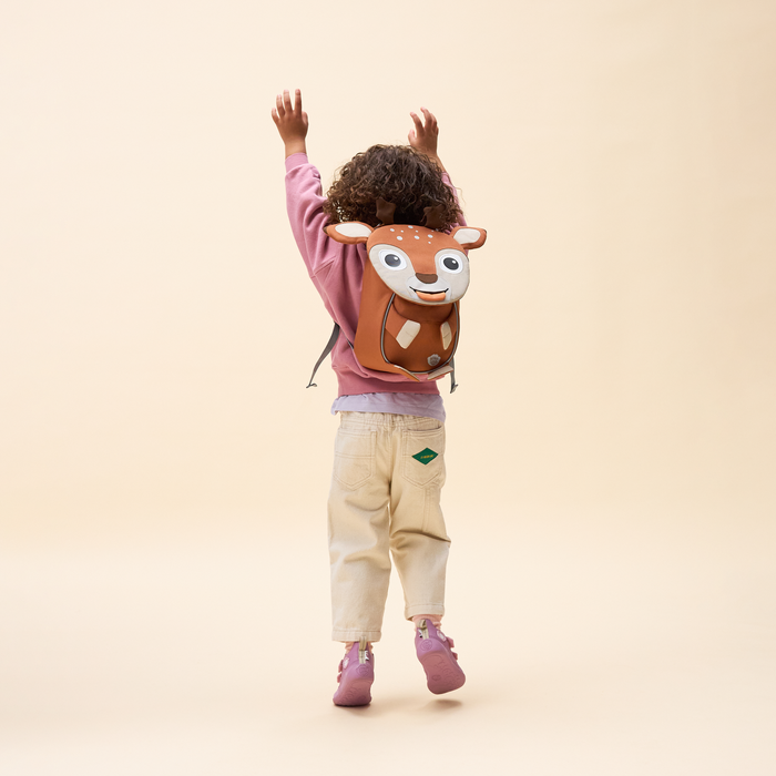 Affenzahn Small Friend Deer backpack worn by a toddler, illustrating its size and fit.
