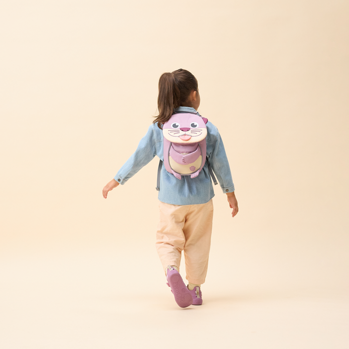 Affenzahn Small Friend otter backpack worn by a toddler, illustrating its size and fit.