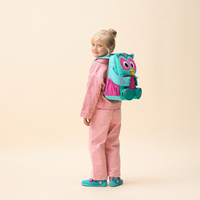 Affenzahn Large Friend Owl backpack worn by a child, illustrating its size and fit.